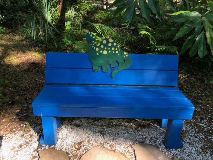 Photo of a bench with a dinosaur on it