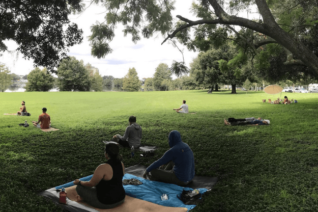 Photo of people doing yoga in Lake Eola - one of the great places to do outdoor yoga in Florida