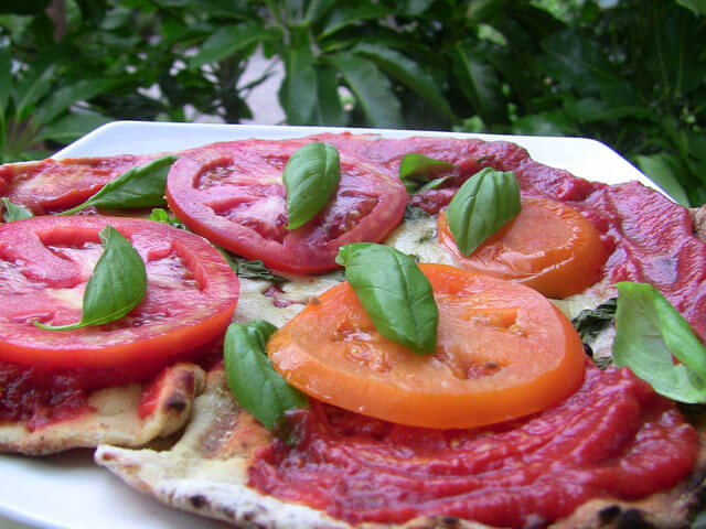 Photo of a flatbread with tomatoes and basil