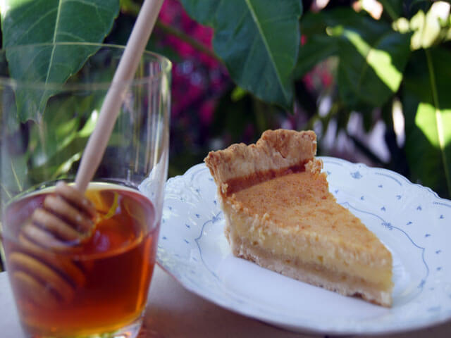 Photo of a slice of pie next to honey