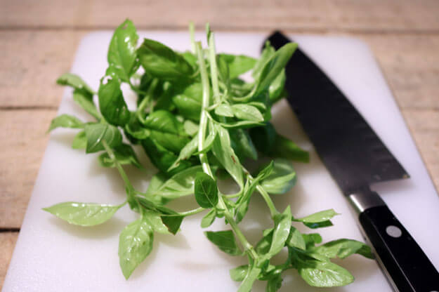 Photo of basil next to a knife