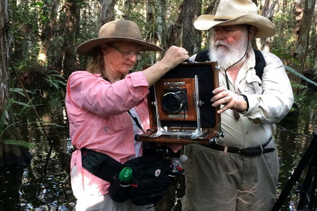 Photo of Clyde and Niki Butcher with a camera