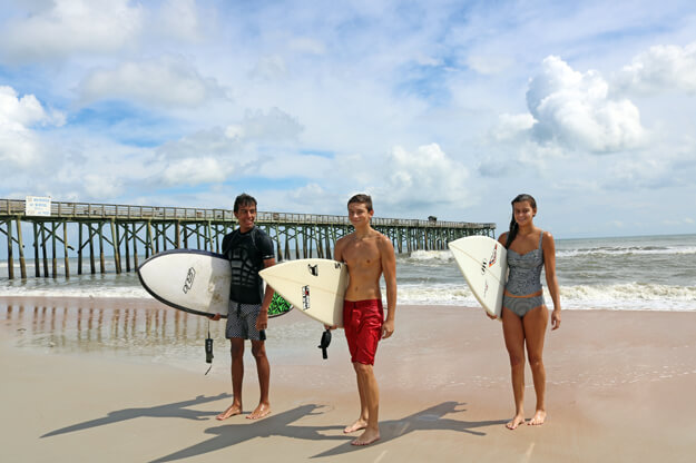 Three surfers on the beach