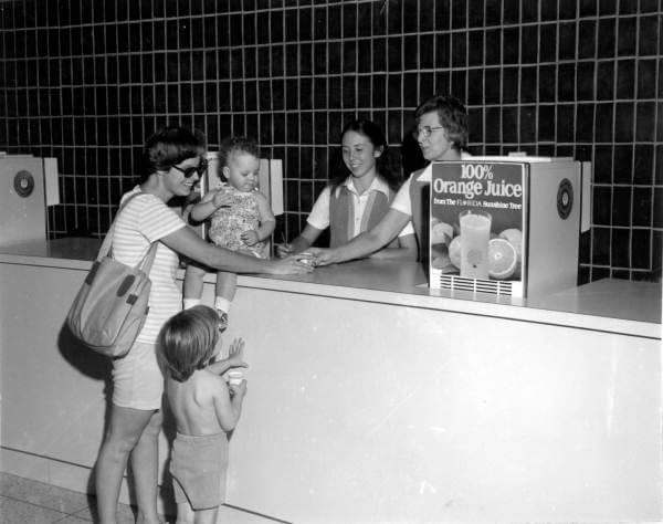 Vintage photo of people getting orange juice