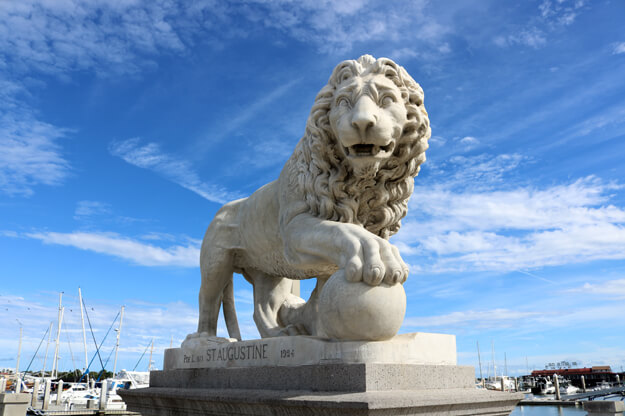Marble lion statue at the base of St. Augustine's Bridge of Lions.