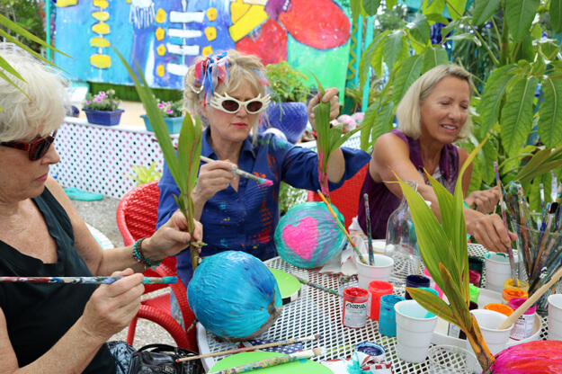 Women painting coconuts.