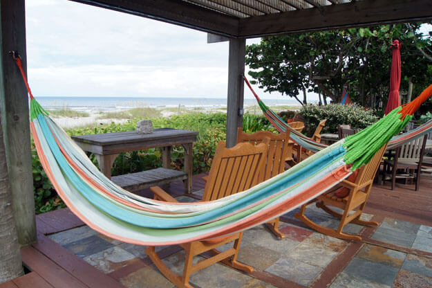 Photo of a hammock and chairs near the beach
