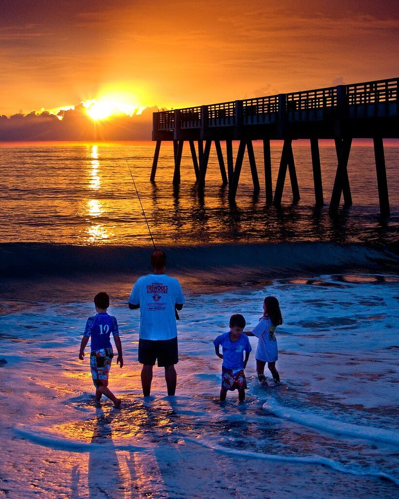 Family fishing at sunset. 