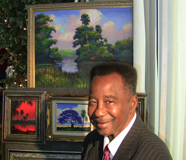 Photo of James Gibson with his paintings