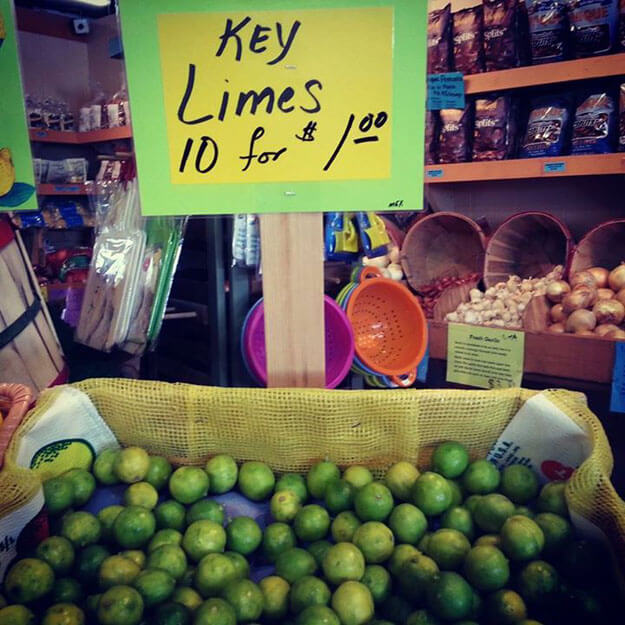 Florida Key limes in a store with a sign that reads Key Limes 10 for $1.00.  