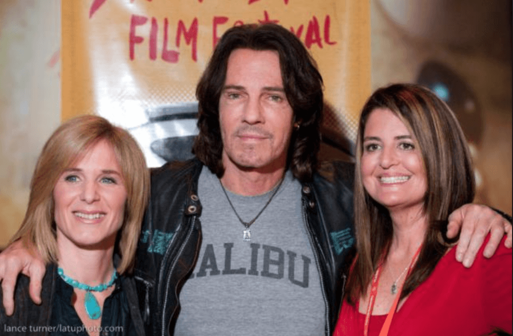 Photo of two women next to Rick Springfield