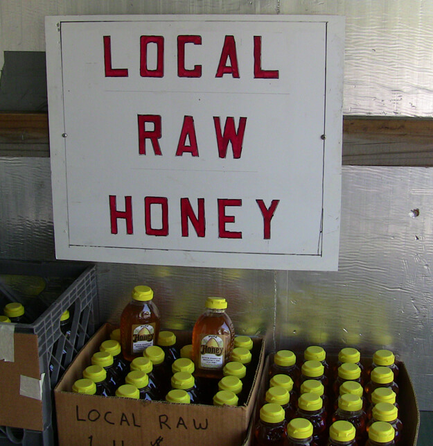 Sign for local raw honey. 