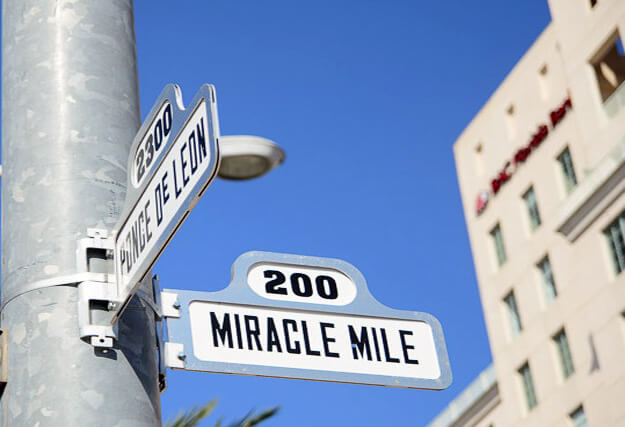 Road sign that reads Miracle Mile and other sign reading Ponce DeLeon. 