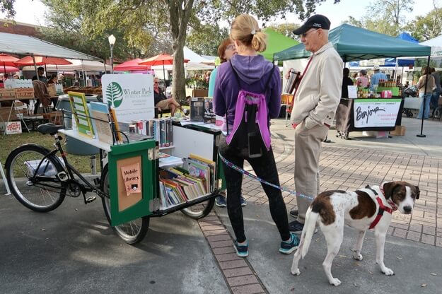 Cart of books at the Farmers Market.