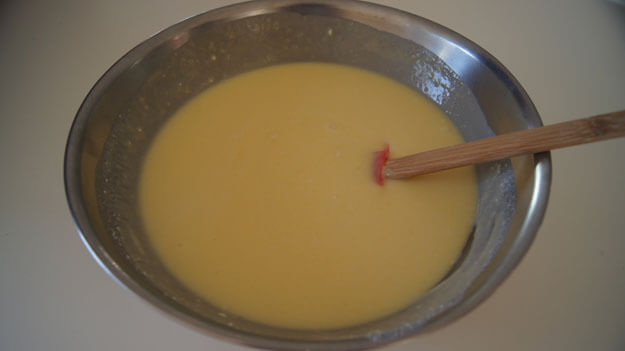 Pureed mango in a bowl with added mix-ins. 