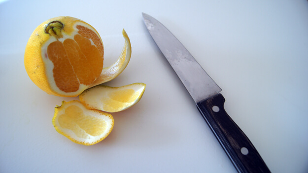 Photo of an orange being peeled