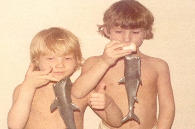 Photo of two young boys with shark toys