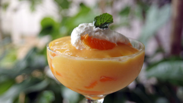 Photo of a tangerine pudding with whipped cream
