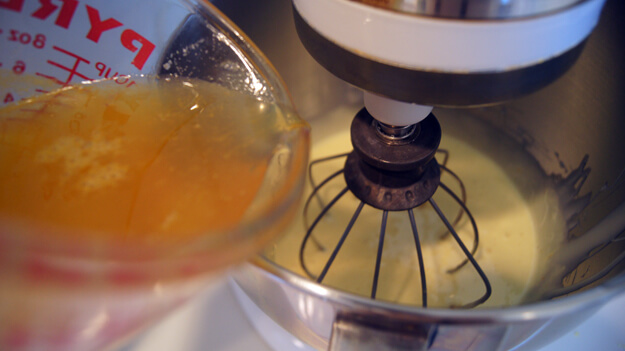 Photo of orange syrup being added to a mixer