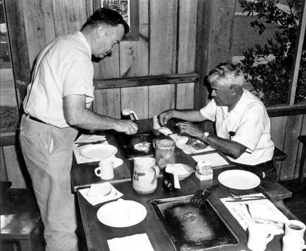 Vintage photo of patrons making pancakes at the Old Spanish Sugar Mill in De Leon Springs