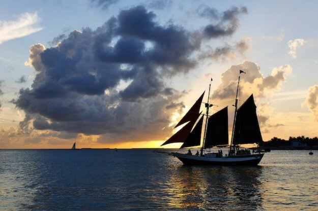 Photo of a sailboat with a sunset in Key West