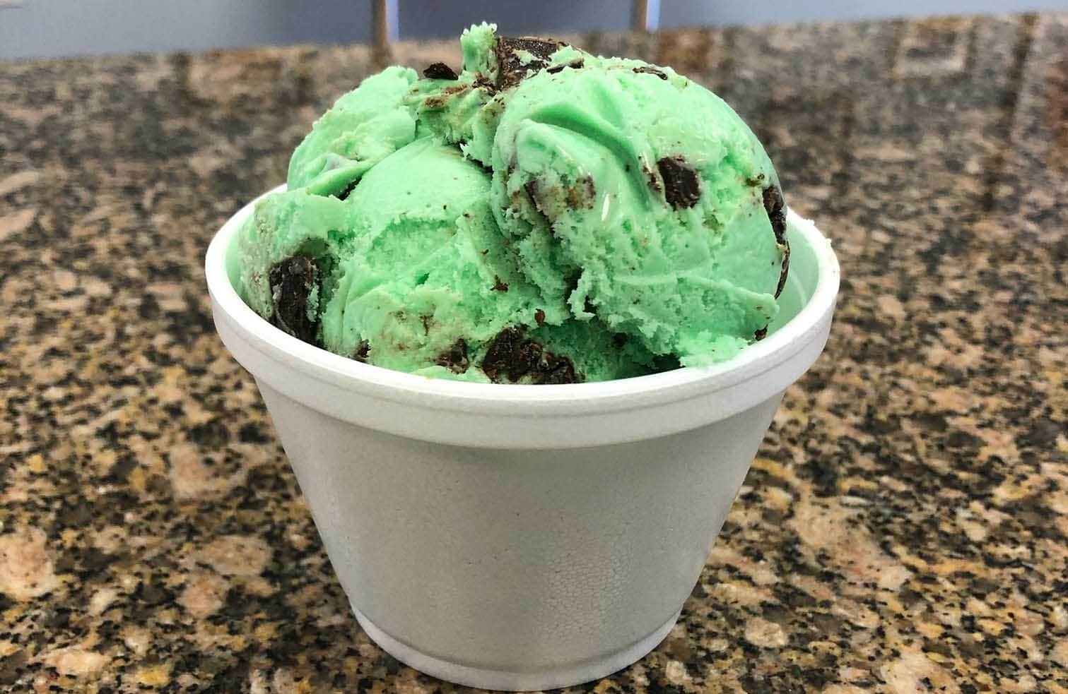 Mint Chocolate chip ice cream in a cup on a counter top 