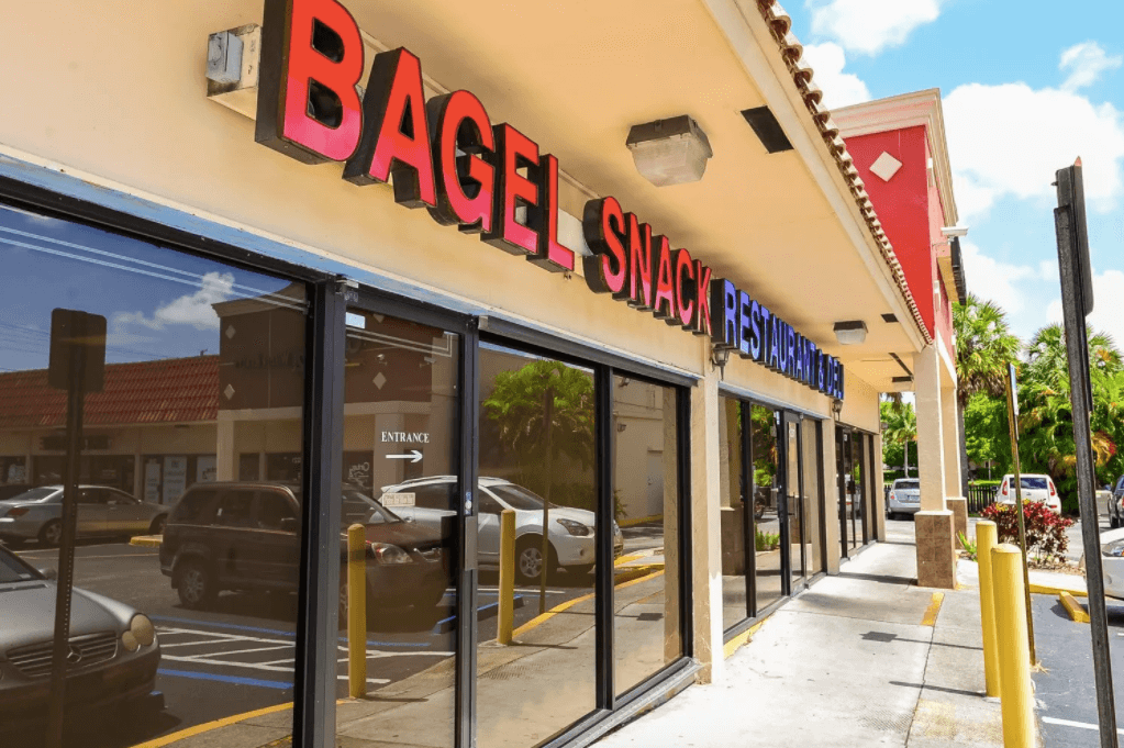 Exterior of a building that reads Bagel Snack Restaurant & Deli. 