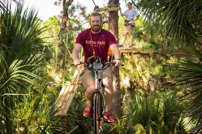 Photo of a man on a bike at the Brevard Zoo Tree Trek
