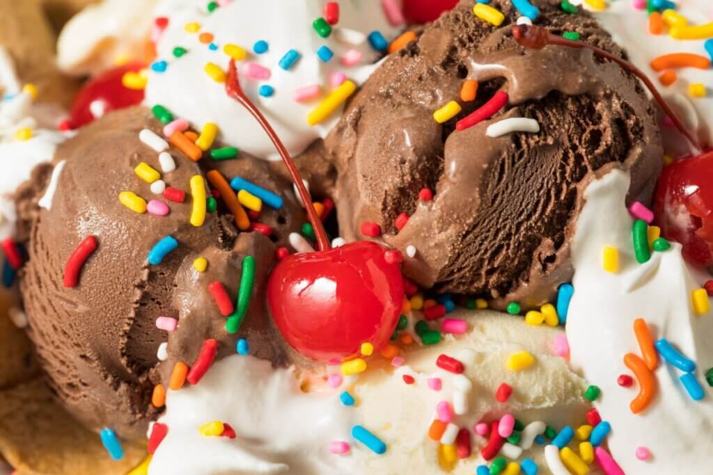 ice cream sundae with sprinkles and a cherry