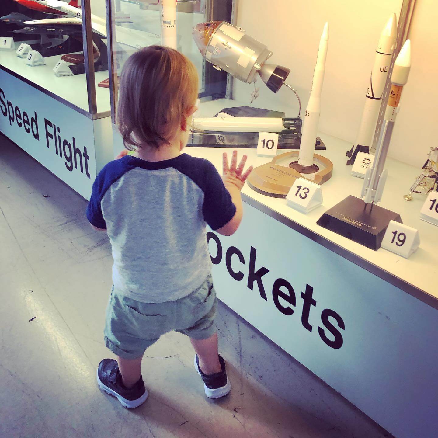Photo of a child in front of an exhibit at the Florida Air Museum