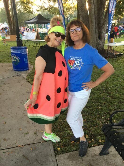 Photo of two women, one dressed as a watermelon
