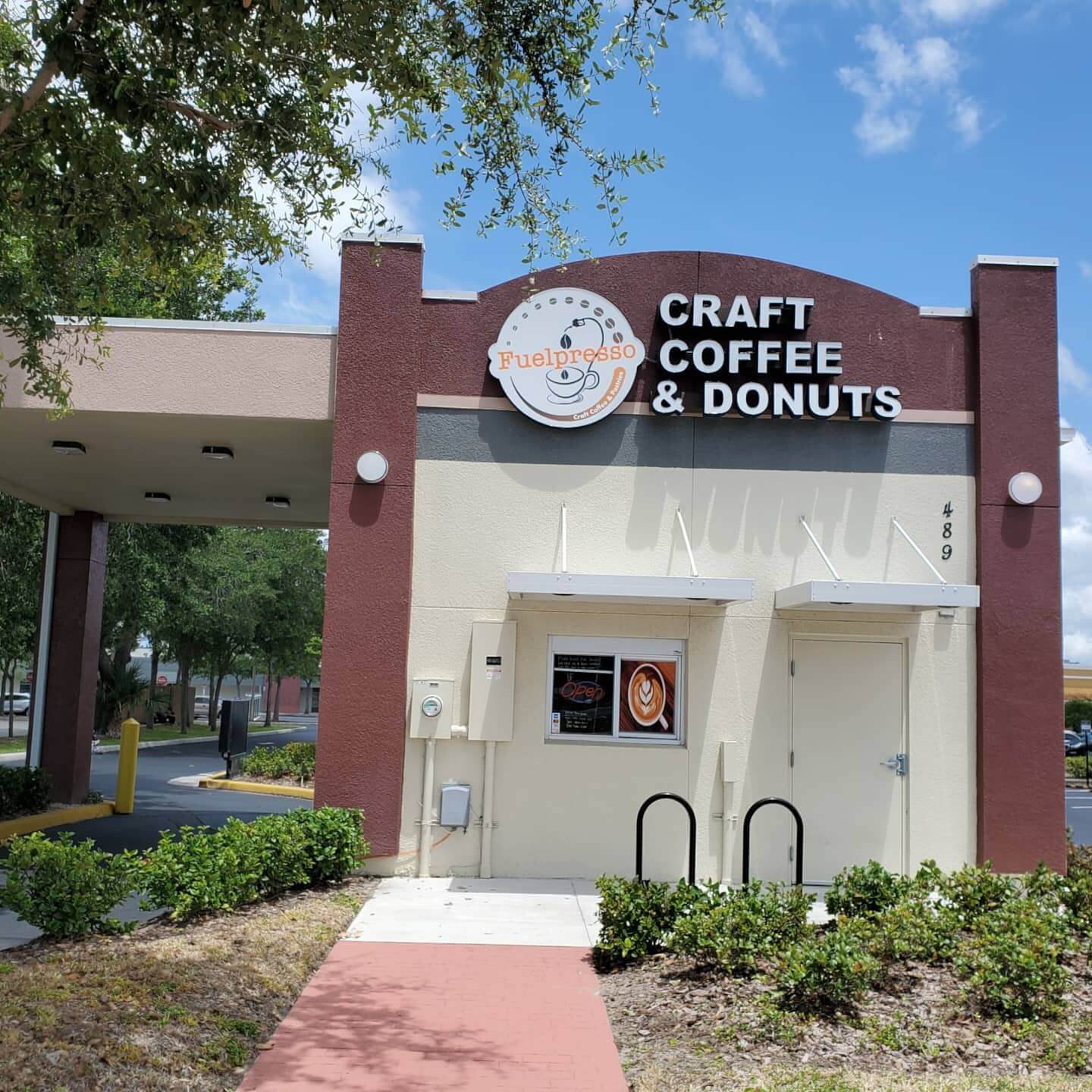 Exterior of a building with the words Fuelspresso Craft Coffee & Donuts on it. 