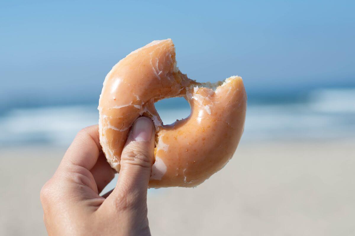 Best Donuts in Florida with a glazed doughnut on the beach