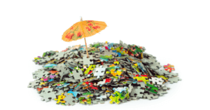 Photo of pile of puzzle pieces with an umbrella