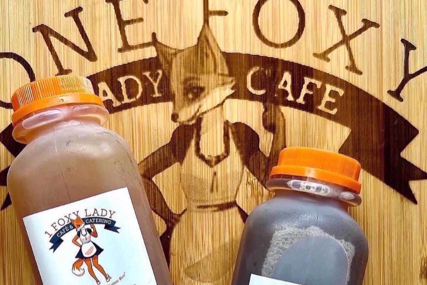 1 foxy Lady Cafe Drinks on a cutting board. 