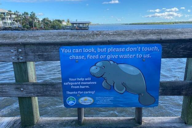 Sign on a dock to not feed the manatees