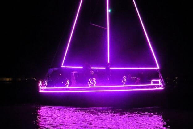 Photo of a sailboat decorated in Christmas Lights