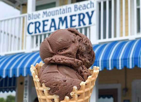 Ice Cream in front of the Blue Mountain Beach Creamery Sign.