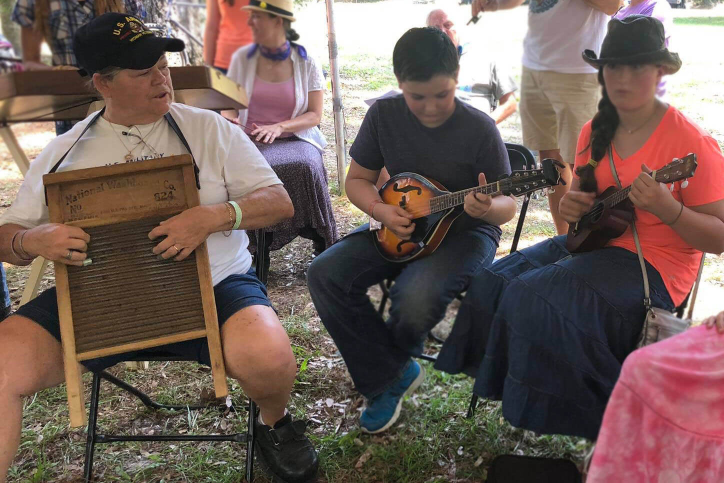 People playing a variety of instruments at Florida Folk Festival.