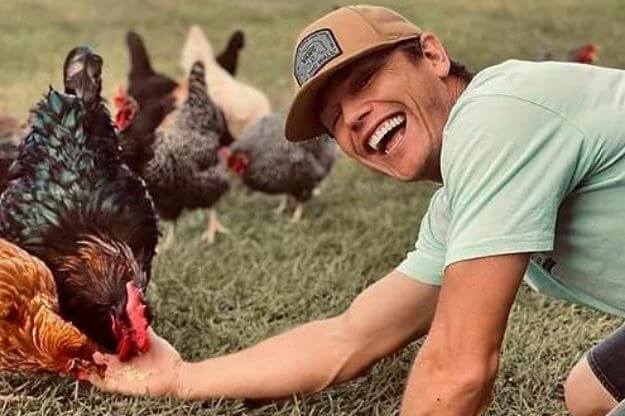 Photo of a man feeding chickens at one of the Unique Resorts in Florida