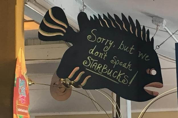 Sign that reads "Sorry, but we don't speak Starbucks!" 