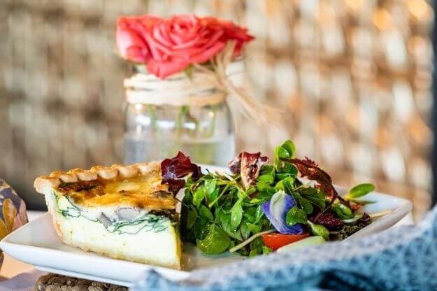 Photo of a quiche on a table.