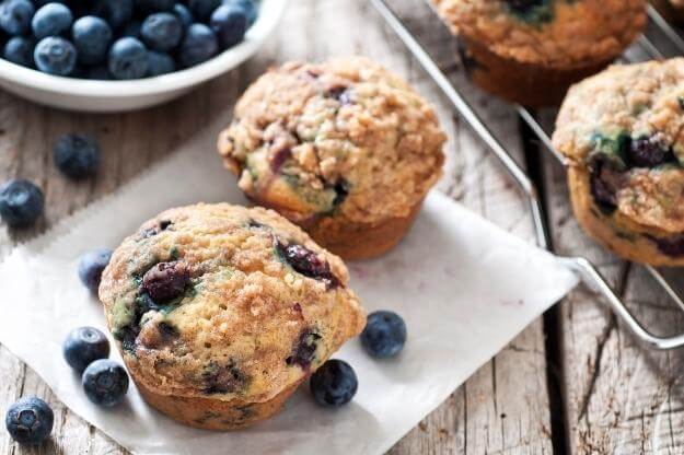 Photo of blueberry muffins with loose fresh blueberries