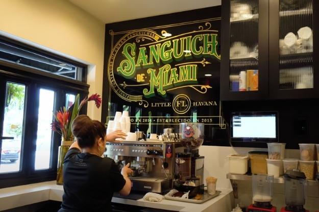 Photo of Sanguich Miami in Little Havana woman making Cuban coffee