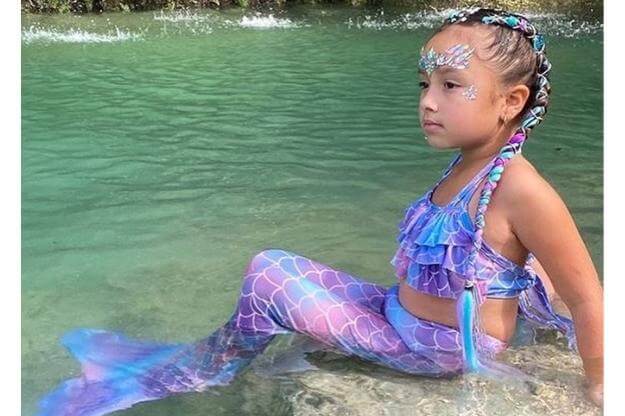 Child dressed as a mermaid. 