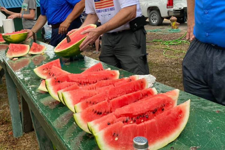 men slicing watermelon 