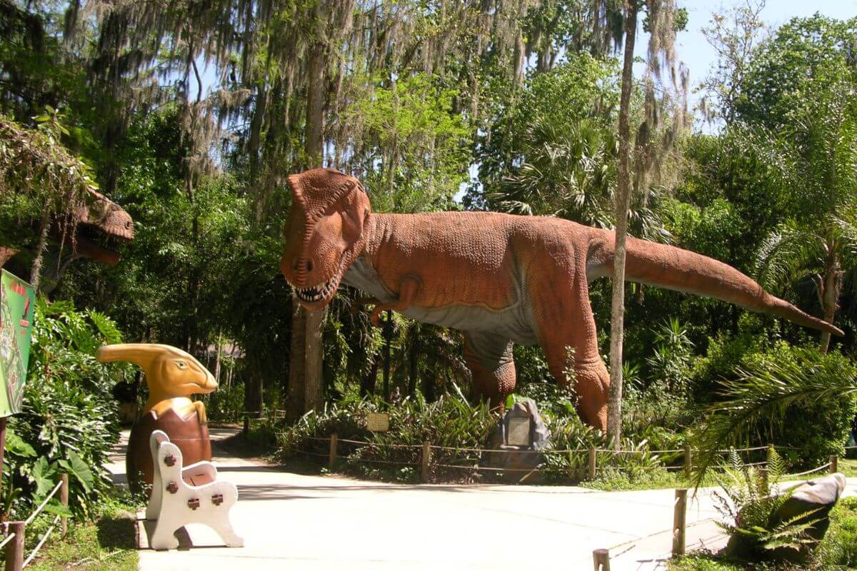 Sidewalk at Dinosaur World with dinosaur statues. 