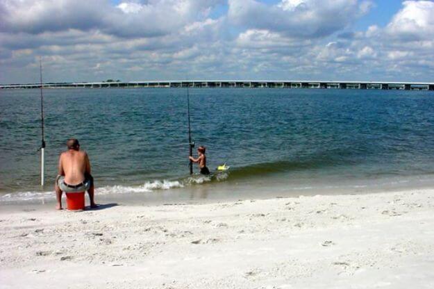 People fishing on beach. 