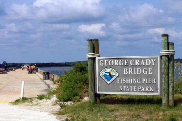 Sign reading George Crady Bridge Fishing Pier State Park. 