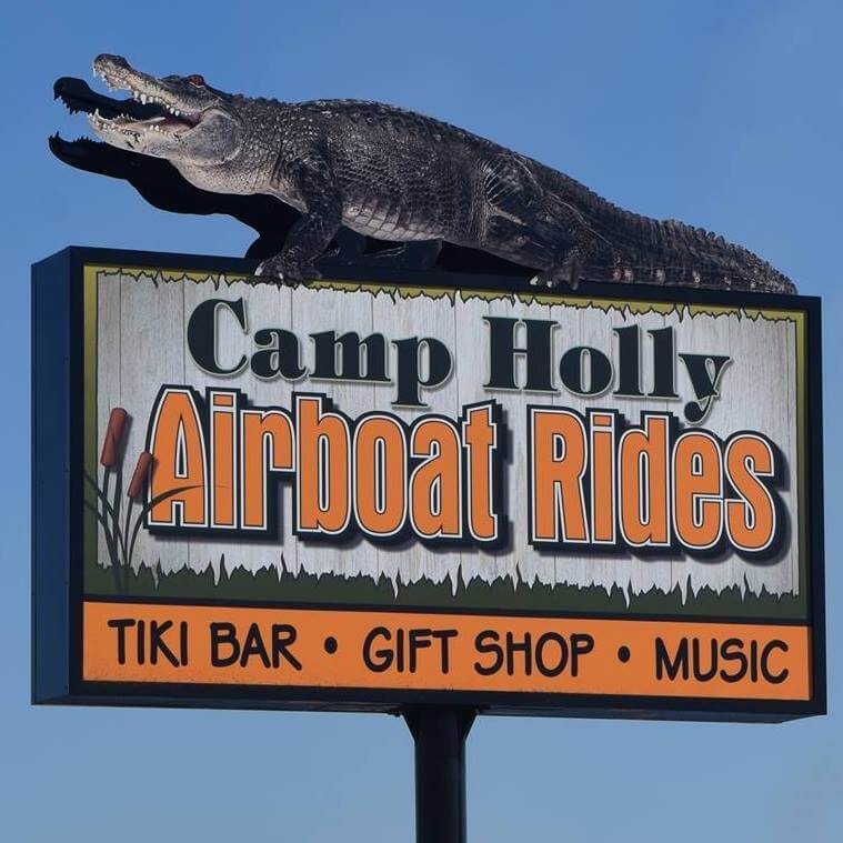 Camp Holly Airboat Rides sign with alligator on top